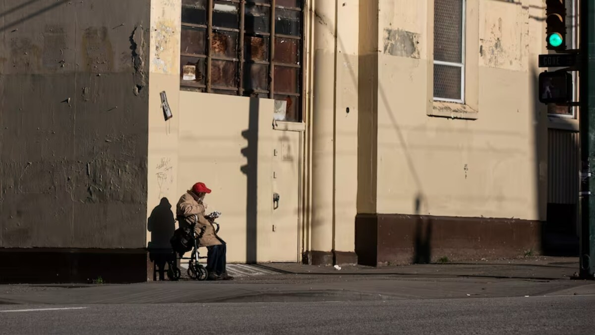 Une personne assise seule au coin d'une rue du quartier Downtown Eastside, à Vancouver, sur une photo non datée.