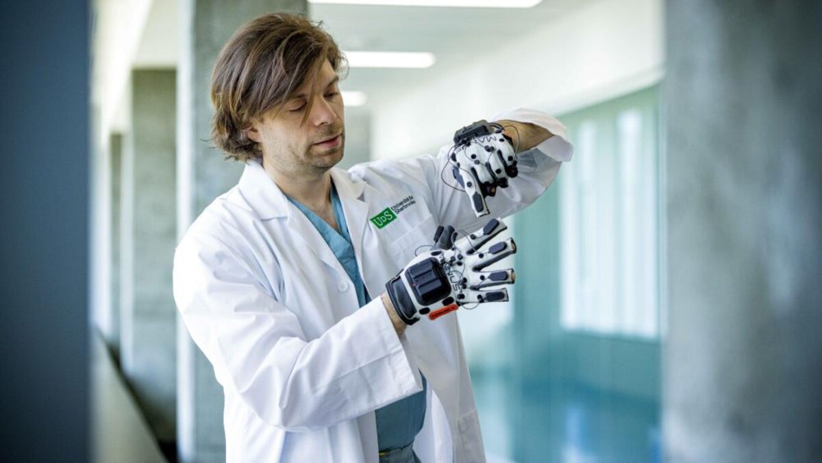 Le Pr Christian lorio-Morin porte les gants haptiques.