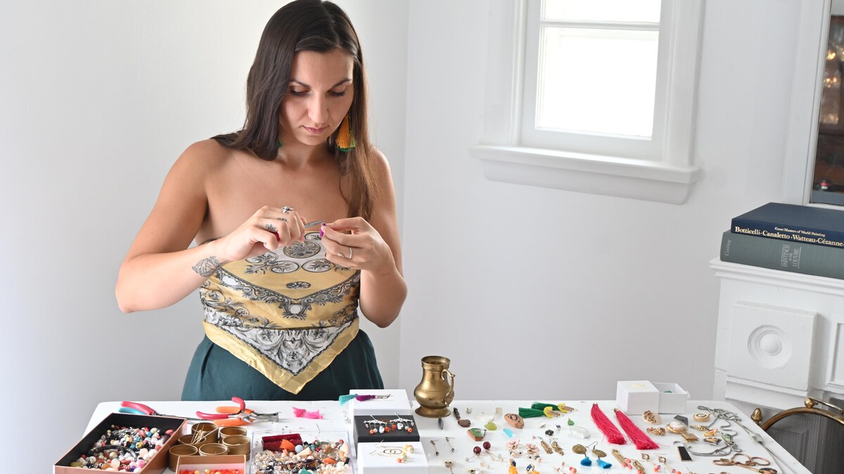 Devant une table remplie d'ancien bijoux, Joëlle Preston crée de nouvelles pièces.