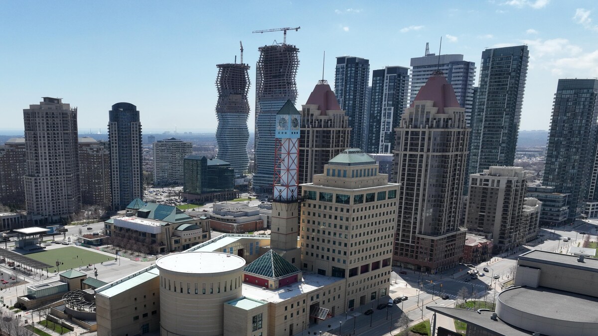 Mississauga City Hall surrounded by residential highrises. See  Celebration Square Clock Tower, Square One, Absolute Condos The "Marilyn Monroe Buildings  and surrounding residential neighbourhoods. 

