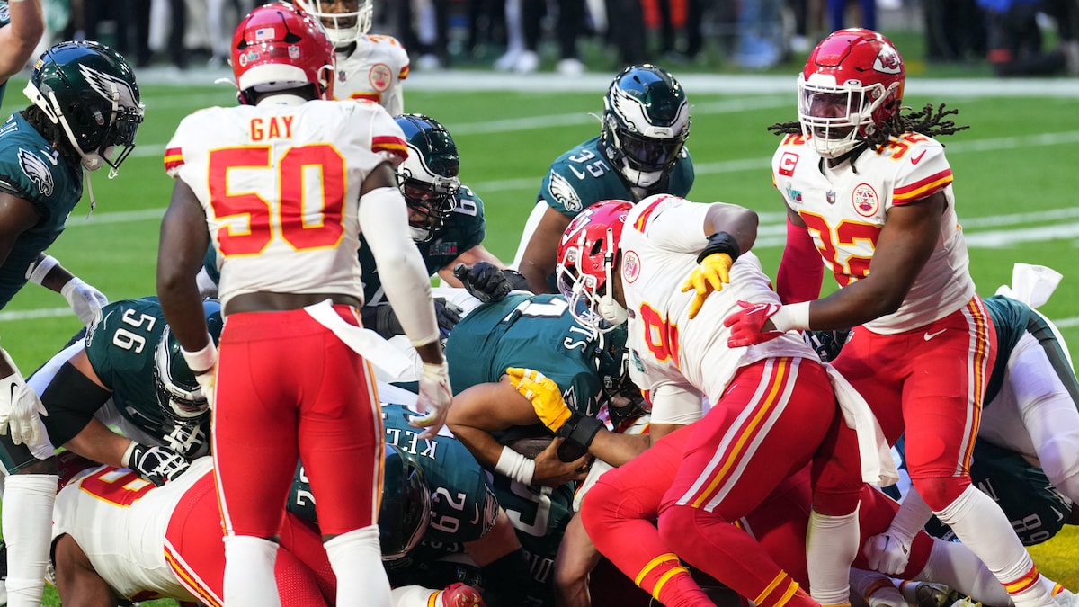 Jalen Hurts being pushed forward by teammates in the 'tush push' play.