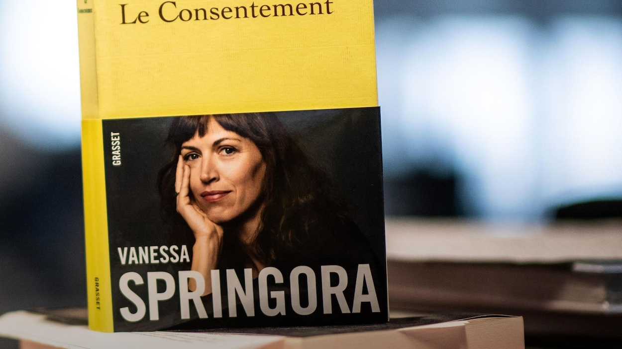 Vue sur le livre à la couverture jaune debout sur une pile d'autres livres.
