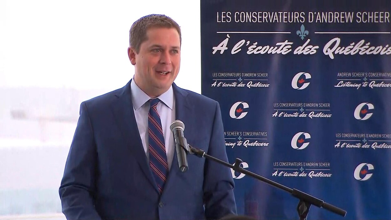 Andrew Scheer, en conférence de presse. « À l'écoute des Québécois », peut-on lire sur une pancarte installée à ses côtés.