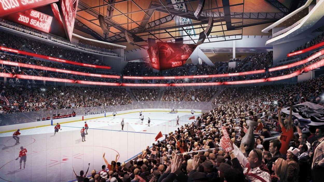 Des spectateurs assistent à une partie de hockey dans le futur aréna de Seattle.