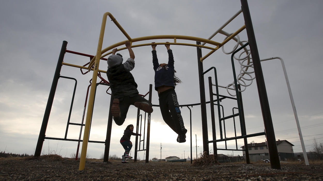 Des enfants jouent dans un parc situé dans la communauté d'Attawapiskat, dans le nord de l'Ontario.