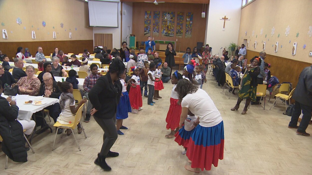 Des enfants et deux animatrices dansent pendant que d’autres personnes assises à leur table les regardent.