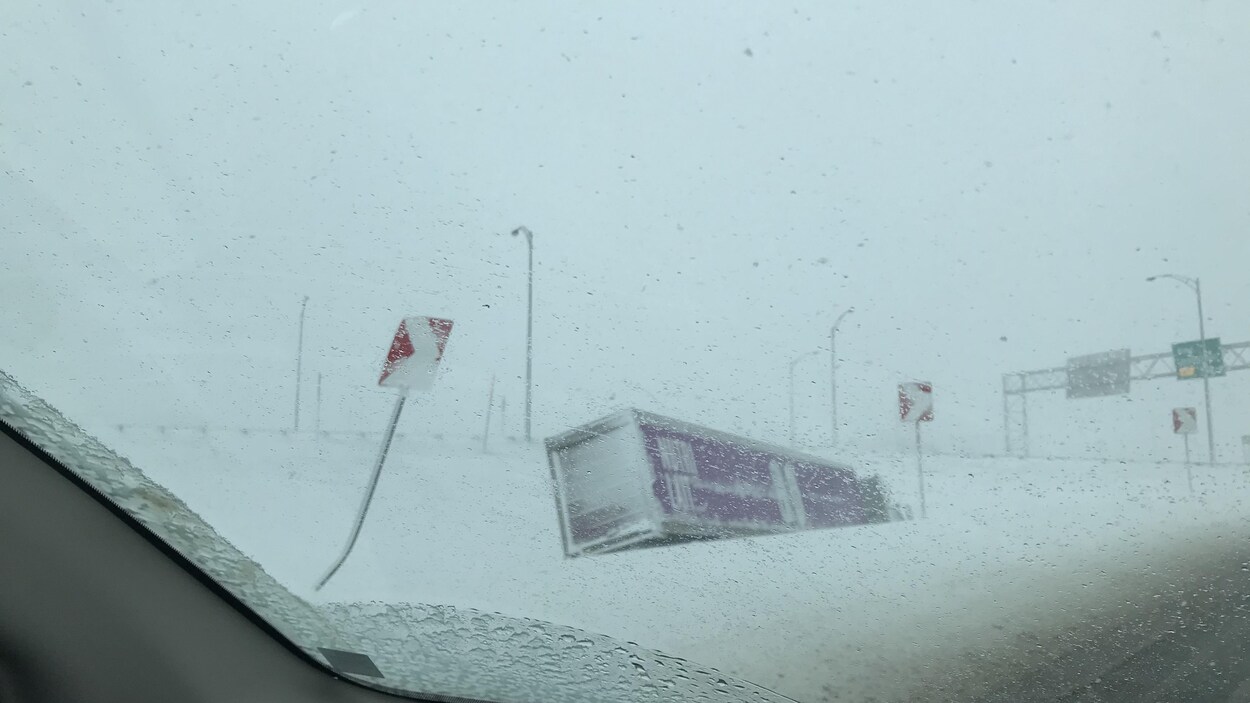 Un camion renversé dans la neige.
