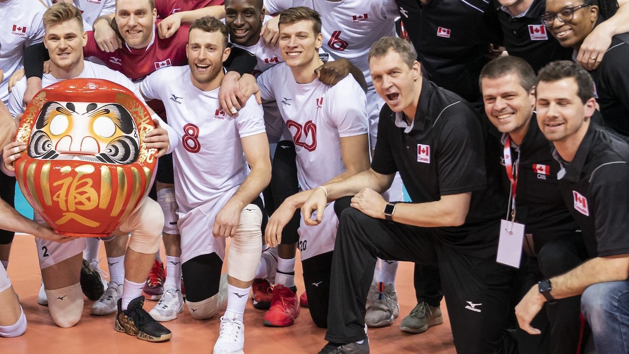 Canada men's national volleyball team poses with a Daruma Doll after winning the NORCECA 2020 Olympic qualification tournament at the Pacific Coliseum and earning a spot at the 2020 Summer Olympic Games in Vancouver on Sunday, January 12, 2020. THE CANADIAN PRESS/Richard Lam