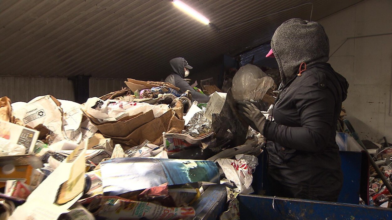 Deux employés dans un centre de tri Récupération 2000 de Cowansville