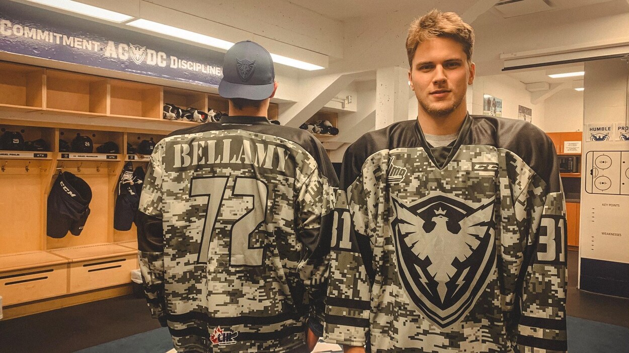 Deux joueurs dans le vestiaire portant un chandail aux couleurs de l'armée.