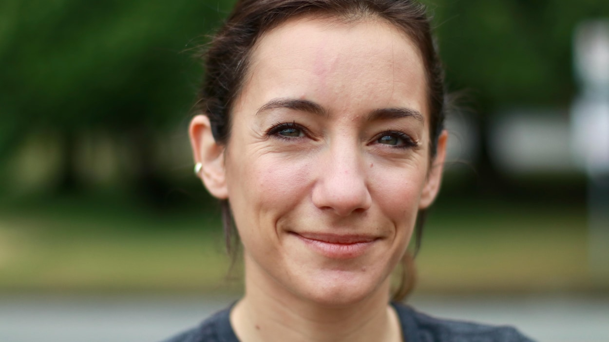 Claire Villet, une jeune coureuse, regarde à la caméra avec un sourire bouche fermée.