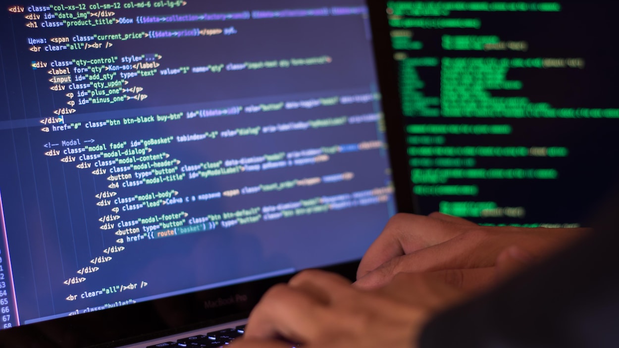 Un homme tape des lignes de code sur un ordinateur portable. Un homme tape des lignes de code sur un ordinateur portable.