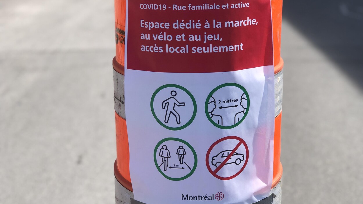 Une affiche avec notamment des indications de distanciation sociale sur un cône de signalisation.