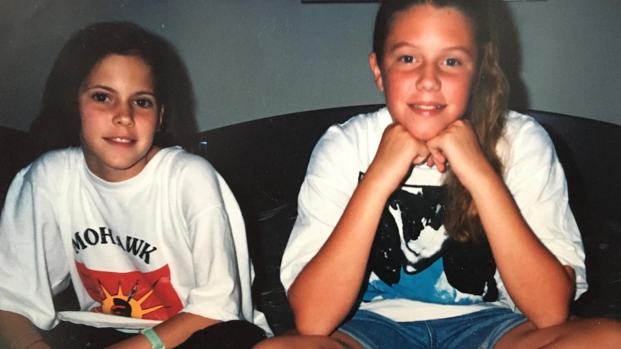Deux jeunes filles assises sur un lit. La photo date des années 1990.