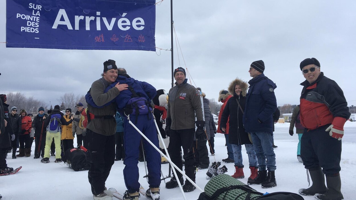 Un participant reçoit une accolade au fil d'arrivée.