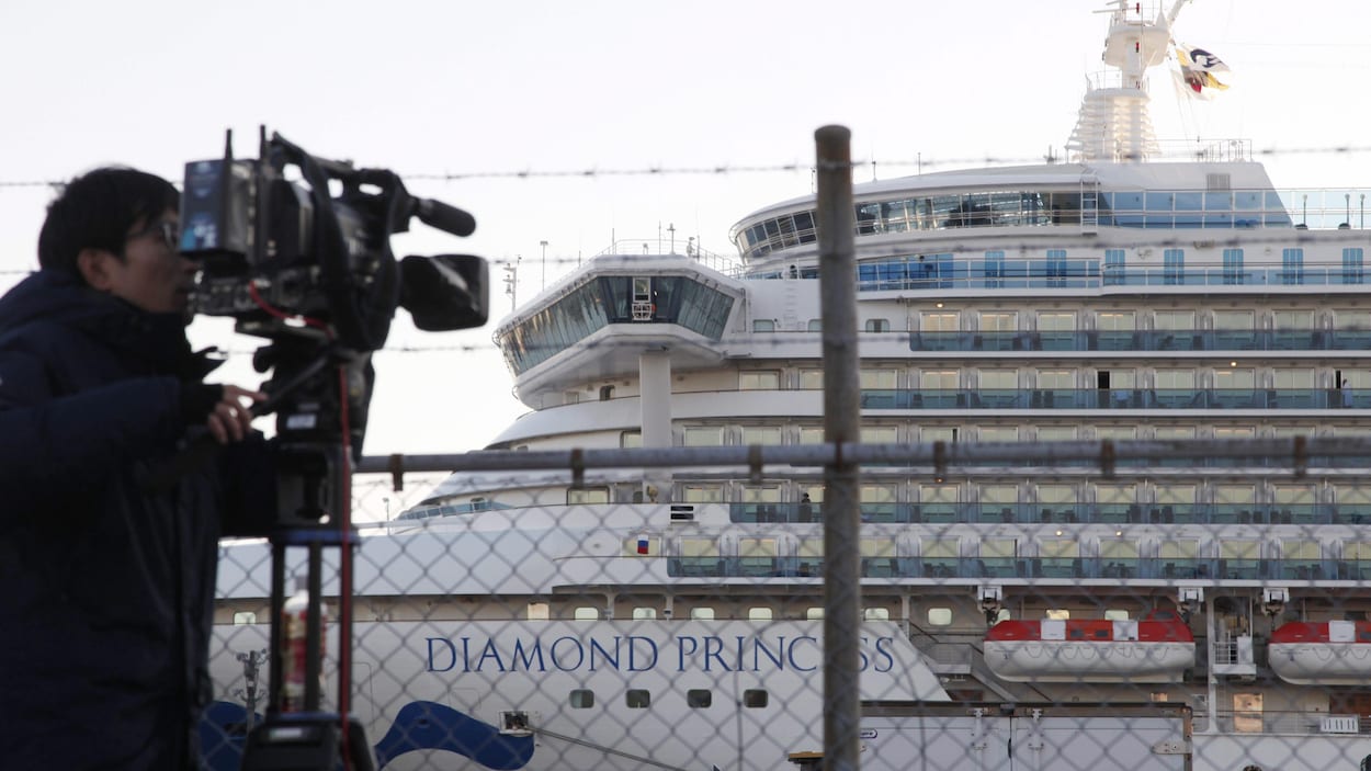 Un caméraman filme le Diamond Princess depuis le rivage.