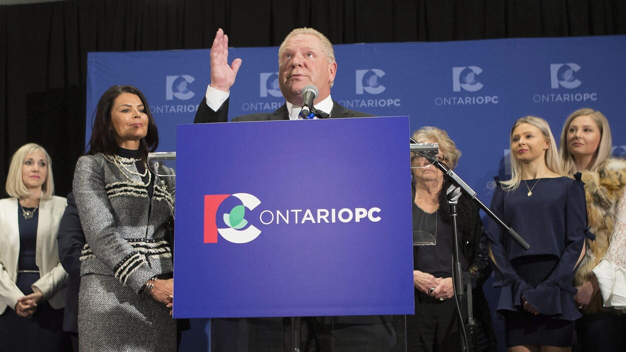 Doug Ford regarde vers le ciel et tient une main dans les airs.