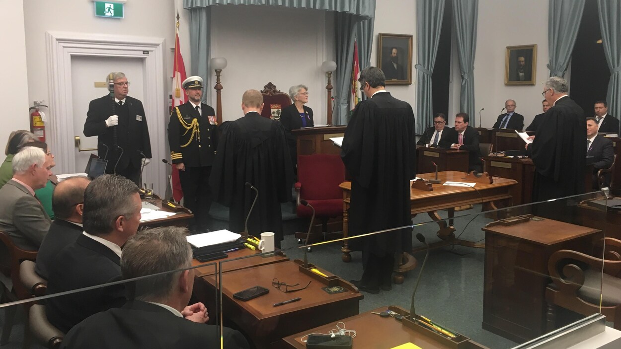 Des députés sont assis et écoutent la lieutenante-gouverneure alors qu'elle donne la sanction royale à des projets de loi.