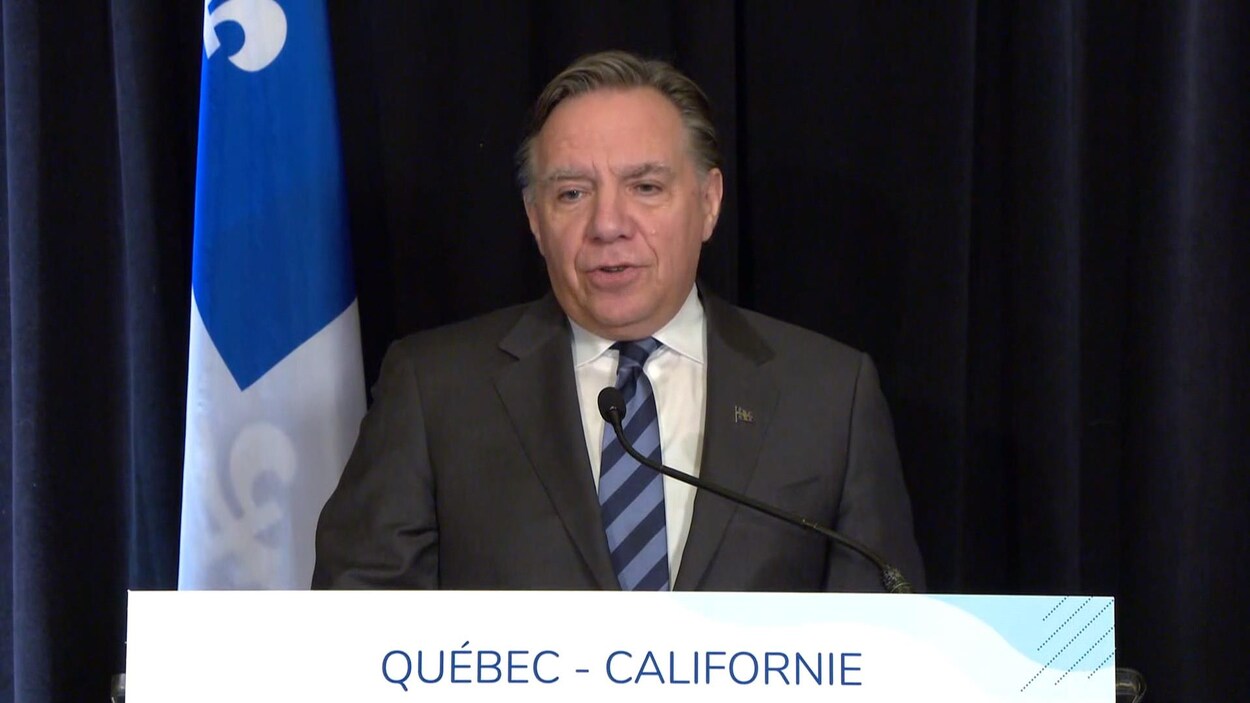 François Legault debout derrière un lutrin.