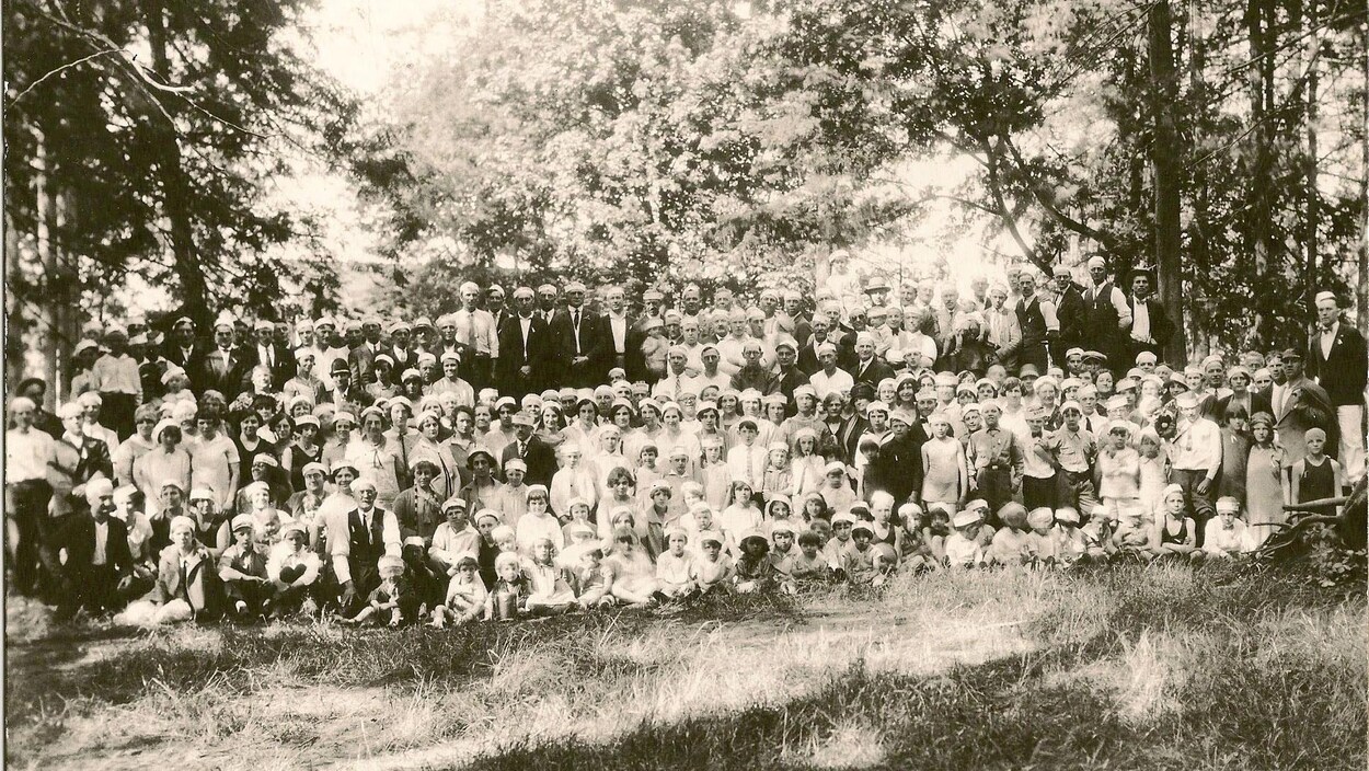 Des gens posent en plein air sur une photo en noir et blanc