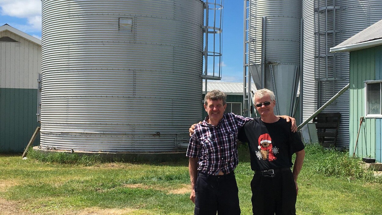 Les frères Parenteau au lendemain de leur aventure, Richard et Raymond devant le fameux silo à grains.