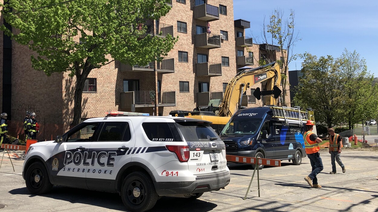 Une voiture du Service de police de Sherbrooke stationnée devant un immeuble à logement évacué en raison d'une fuite de gaz.