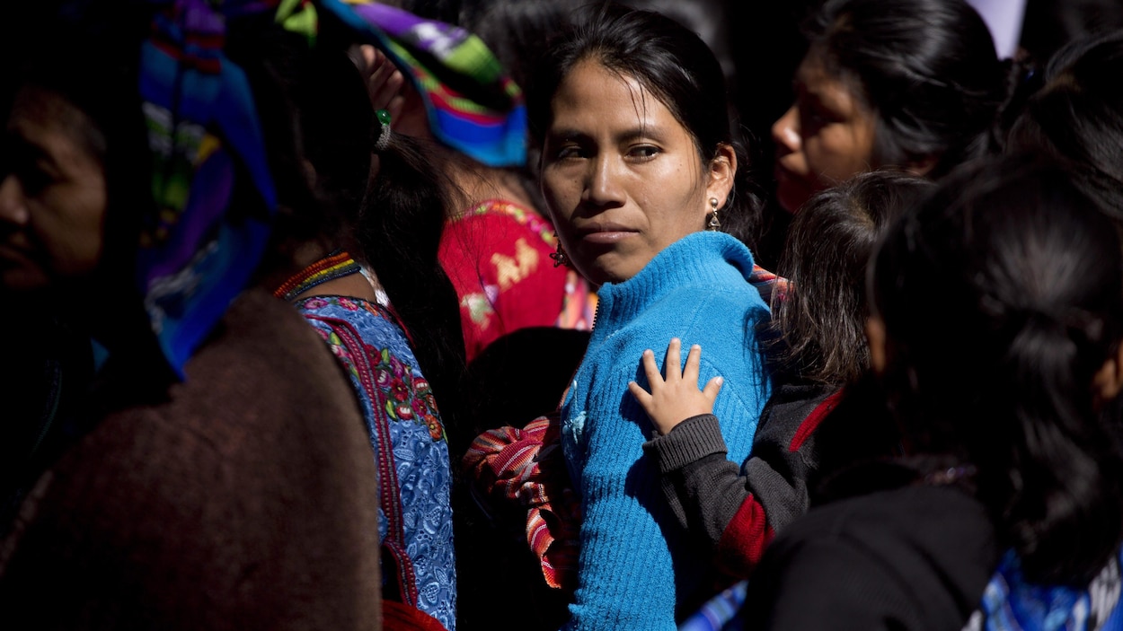 Une militante porte sa fille sur son dos lors des manifestations pour les droits de la femme à Guatemala.