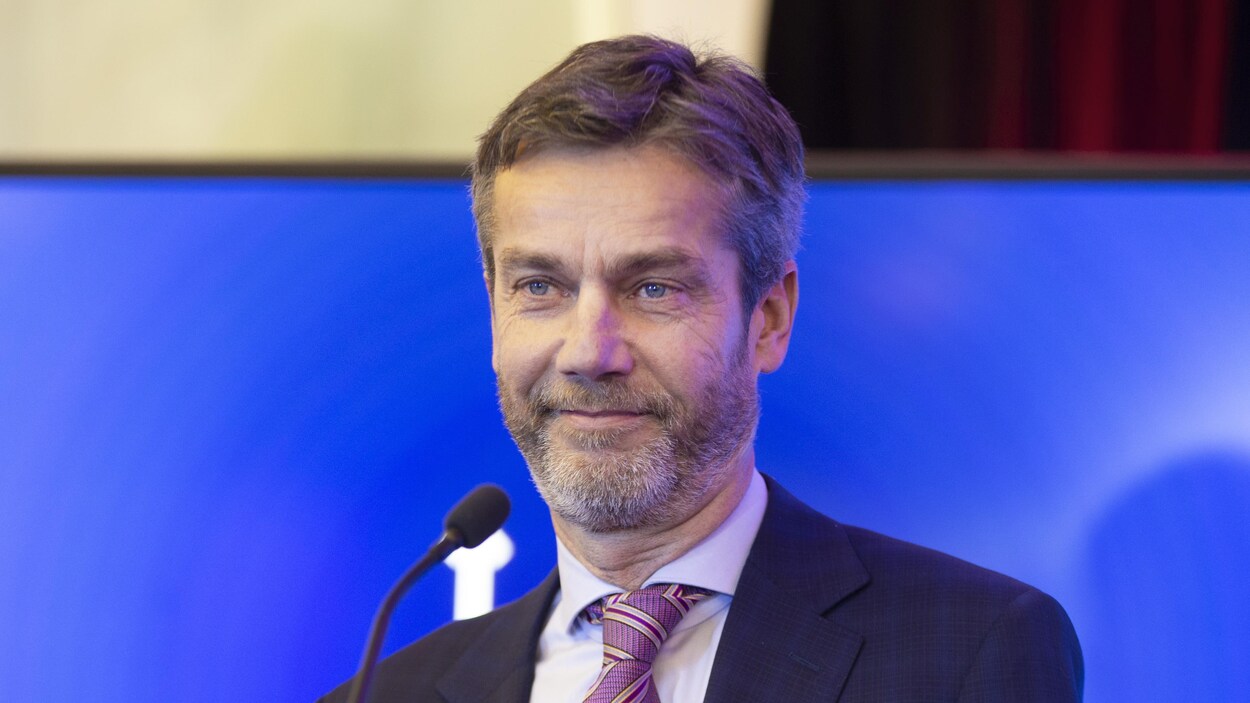 Guy Leblanc derrière un micro.