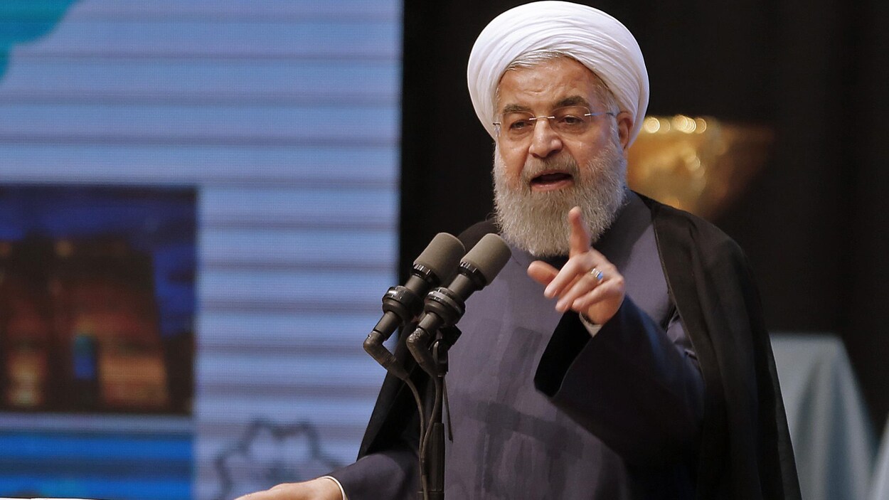 Hassan Rouhani parle dans un micro. Hassan Rouhani parle dans un micro.