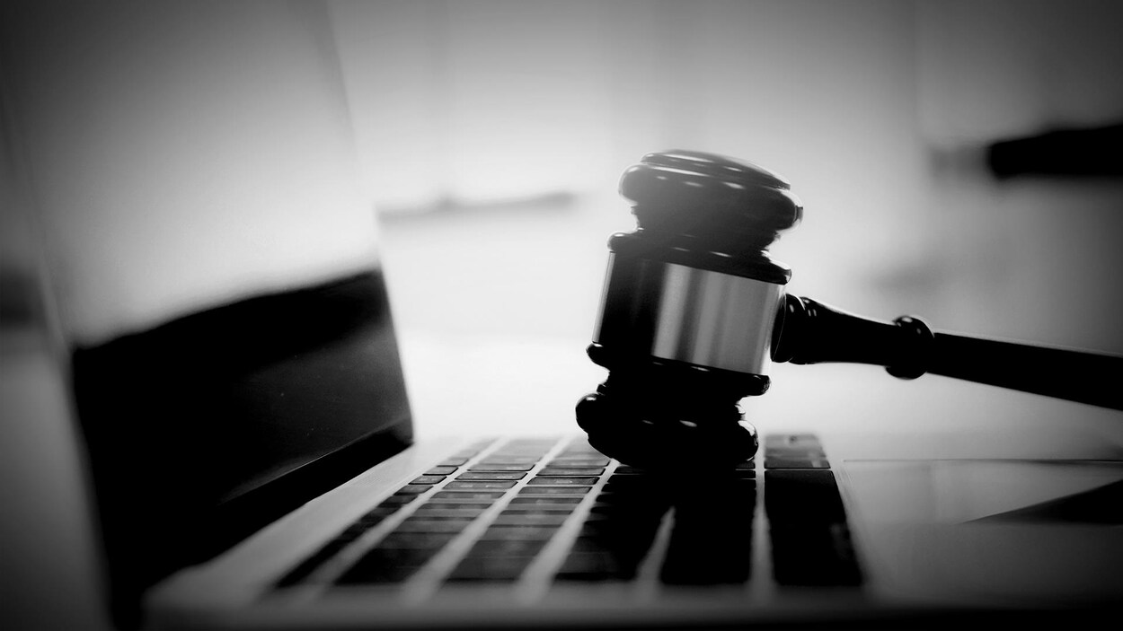 Un maillet de juge sur le clavier d’un ordinateur portable.