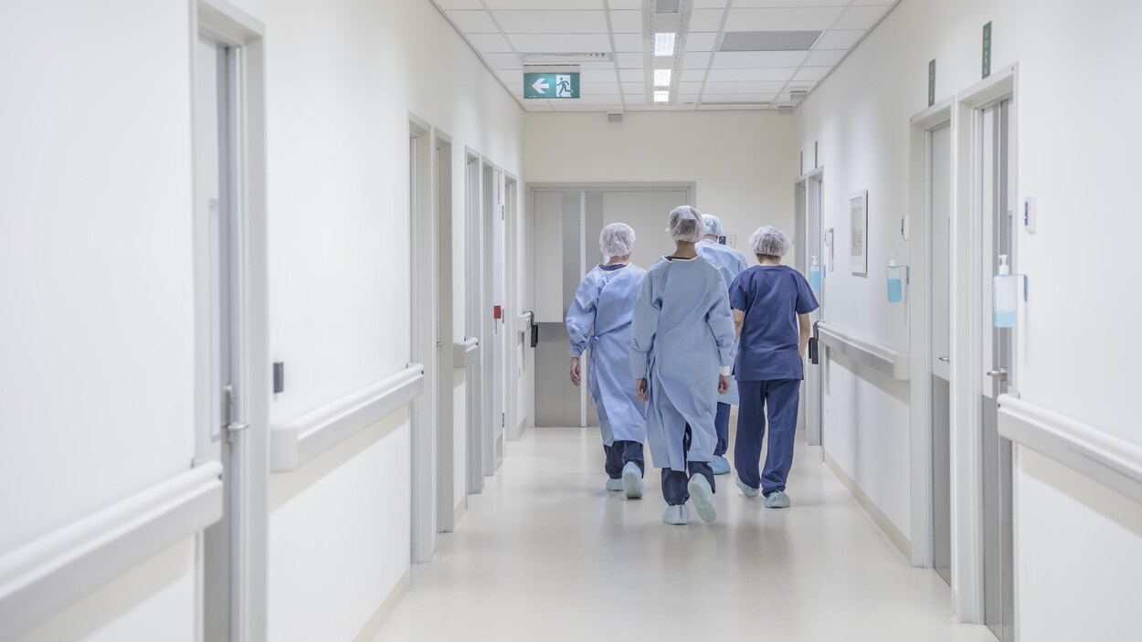 Une équipe médicale se rend dans une salle de chirurgie.