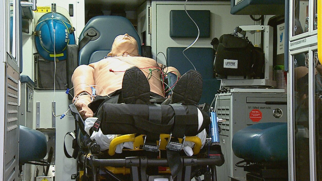 Un mannequin assis sur une civière dans une ambulance.