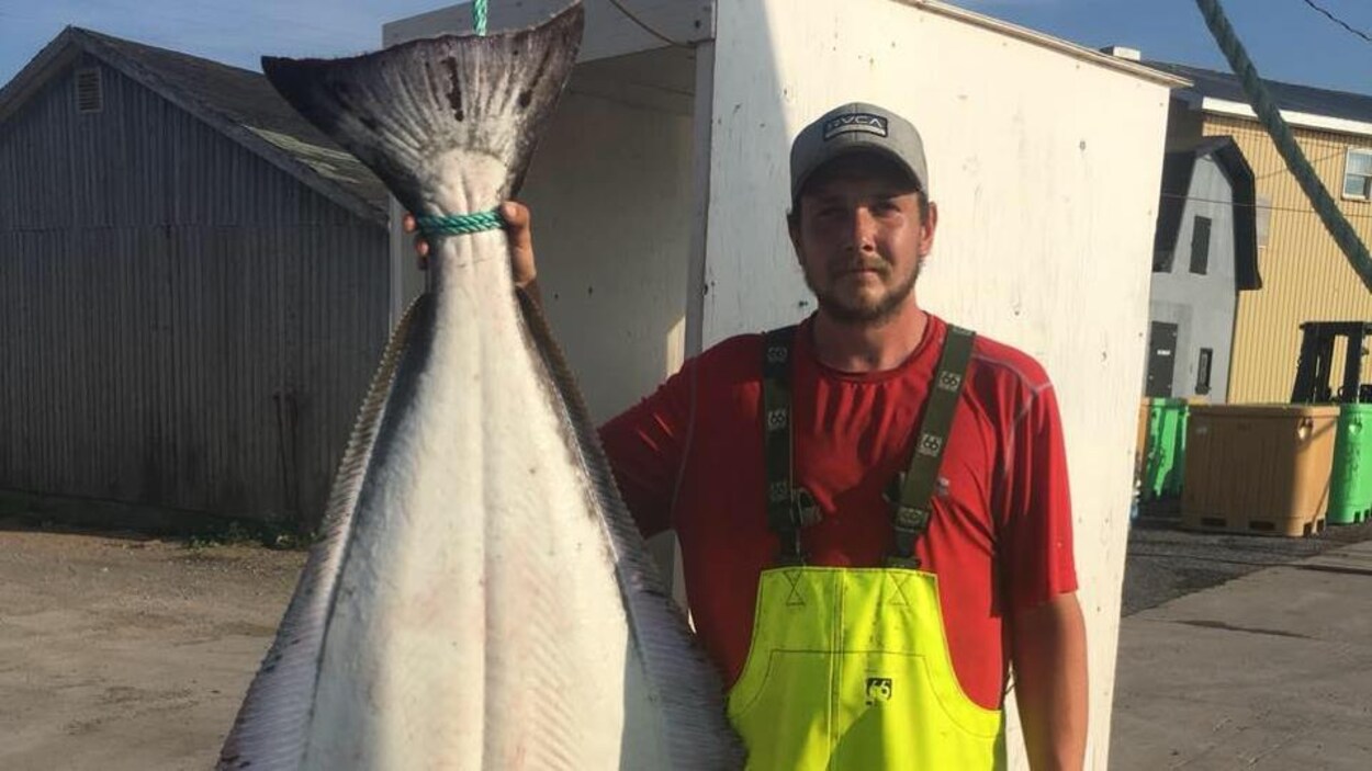 Une photo du jeune pêcheur avec un poisson.