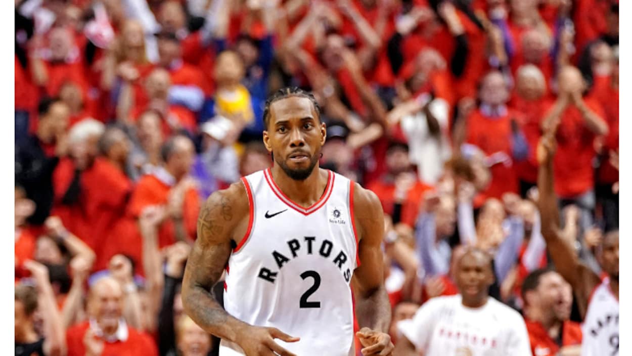 Le basketteur est debout sur le terrain avec la foule de l'aréna Banque Scotia en arrière-plan.