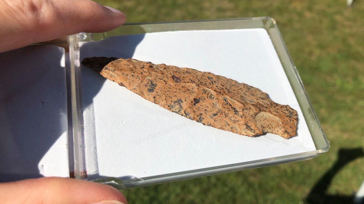La lance, sculptée dans de la pierre orangée, est déposée dans un coffret de conservation.