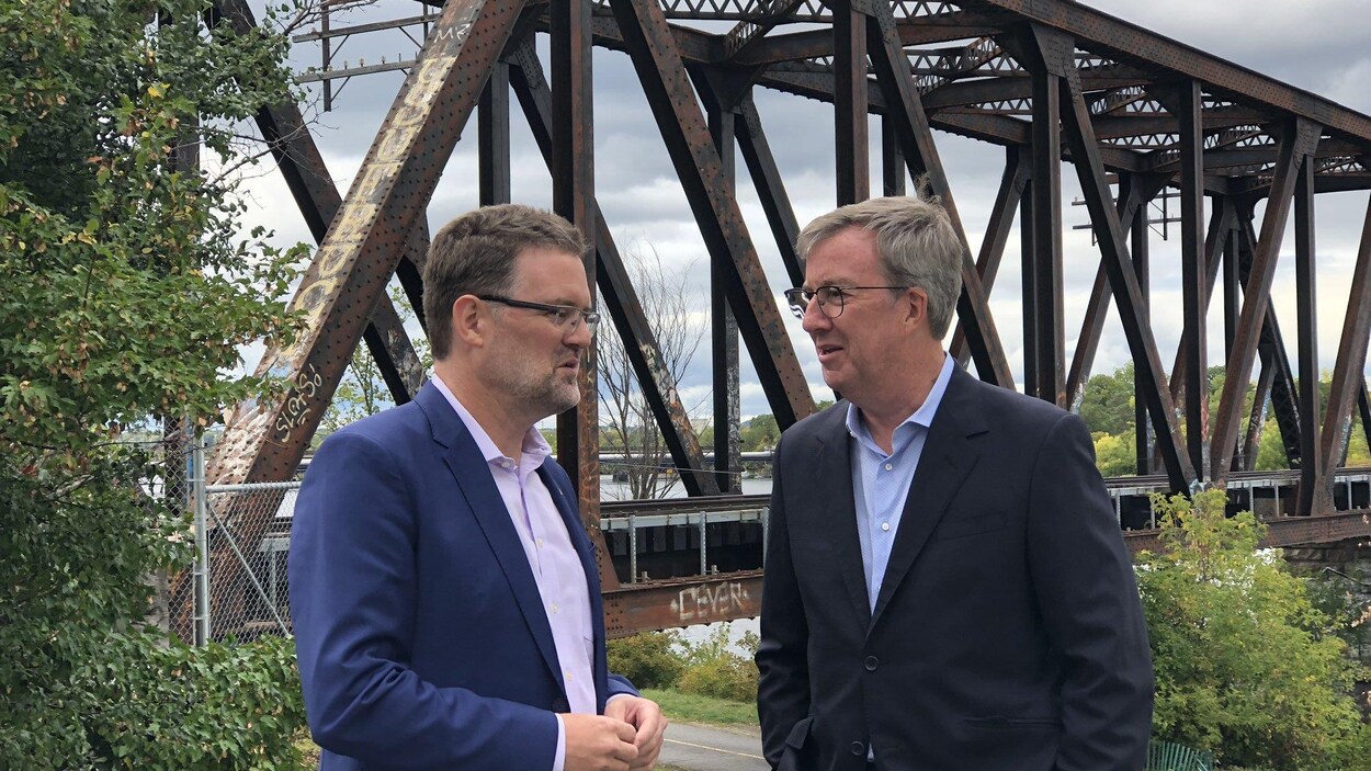 Maxime Pedneaud-Jobin et Jim Watson sont en conversation devant le pont Prince-de-Galles.