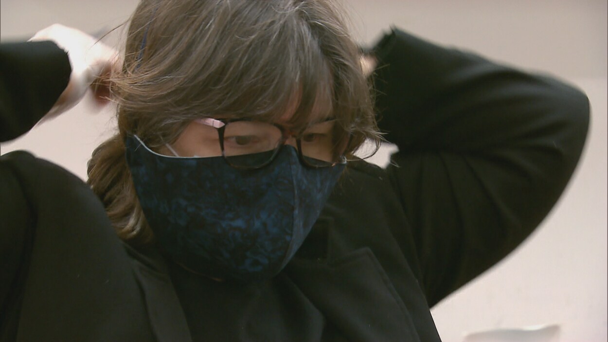 Une femme met un masque.