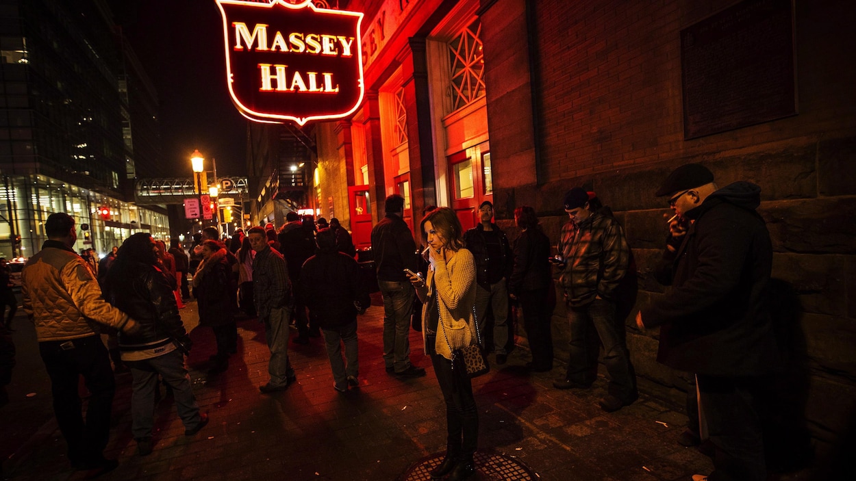 Des spectateurs fument à l'extérieur de la salle de concert Massey Hall en janvier 2014.