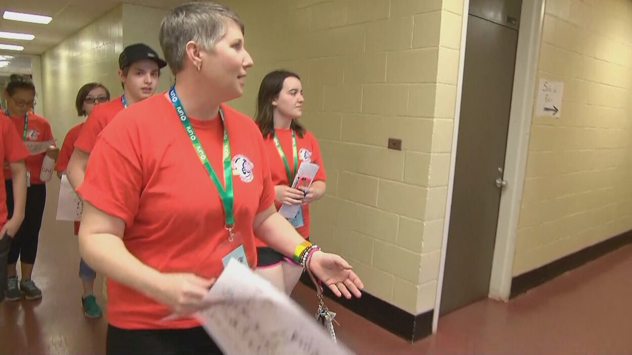 Avec un groupe de bénévole derrière elle, Mélanie Ingersoll s'affaire dans les lieux d'hébergement des Jeux de l'Acadie.