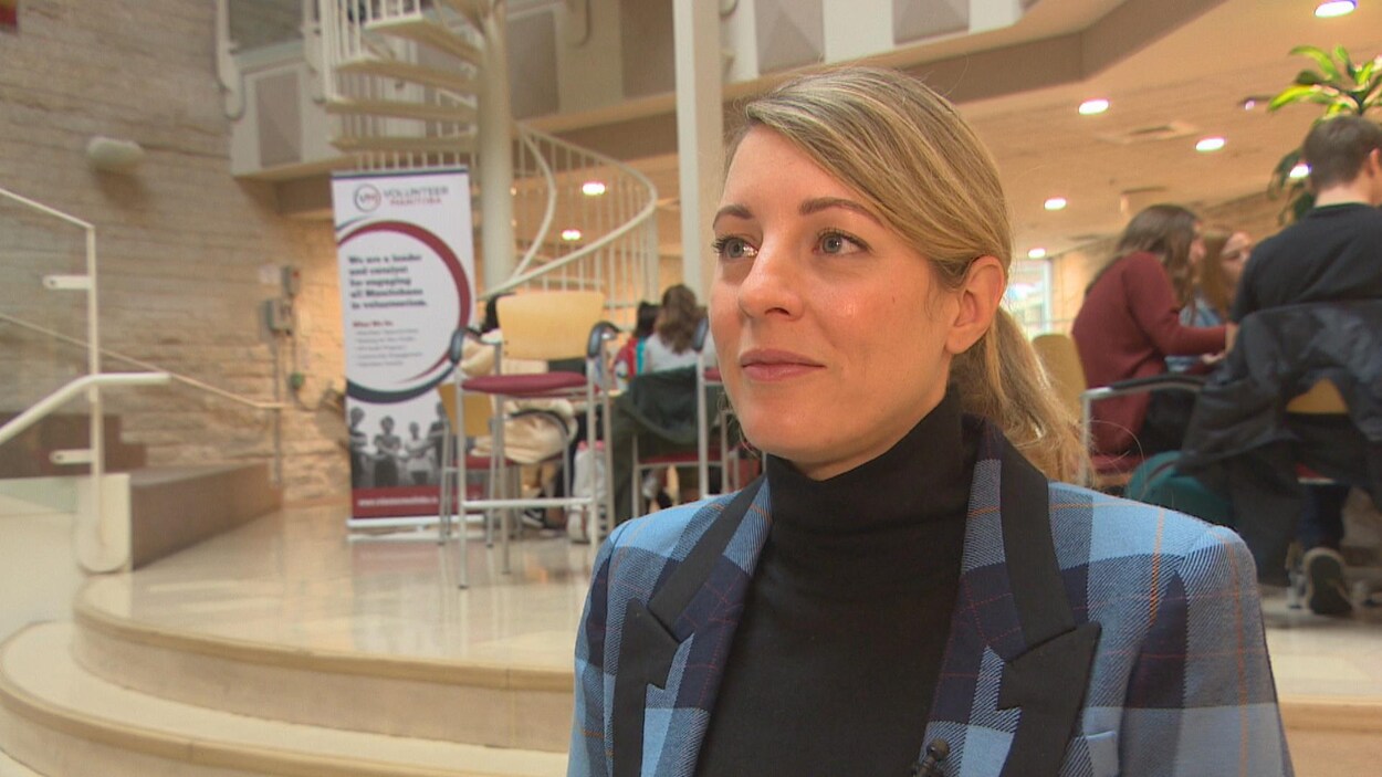 Plan moyen de Mélanie Joly dans un hall d'université.