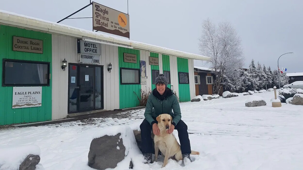Melanie Vogel est assise avec son chien devant le motel Eagle Plains.