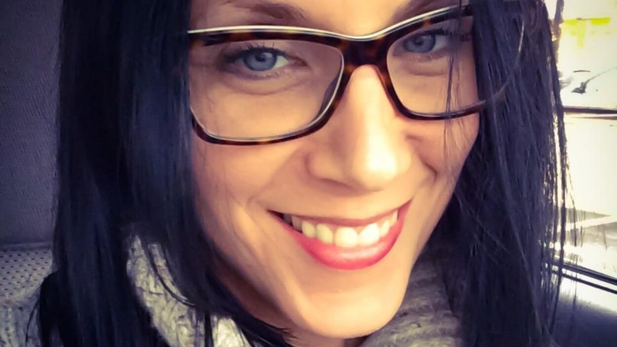 MIchelle Gray souriante au volant de sa voiture.