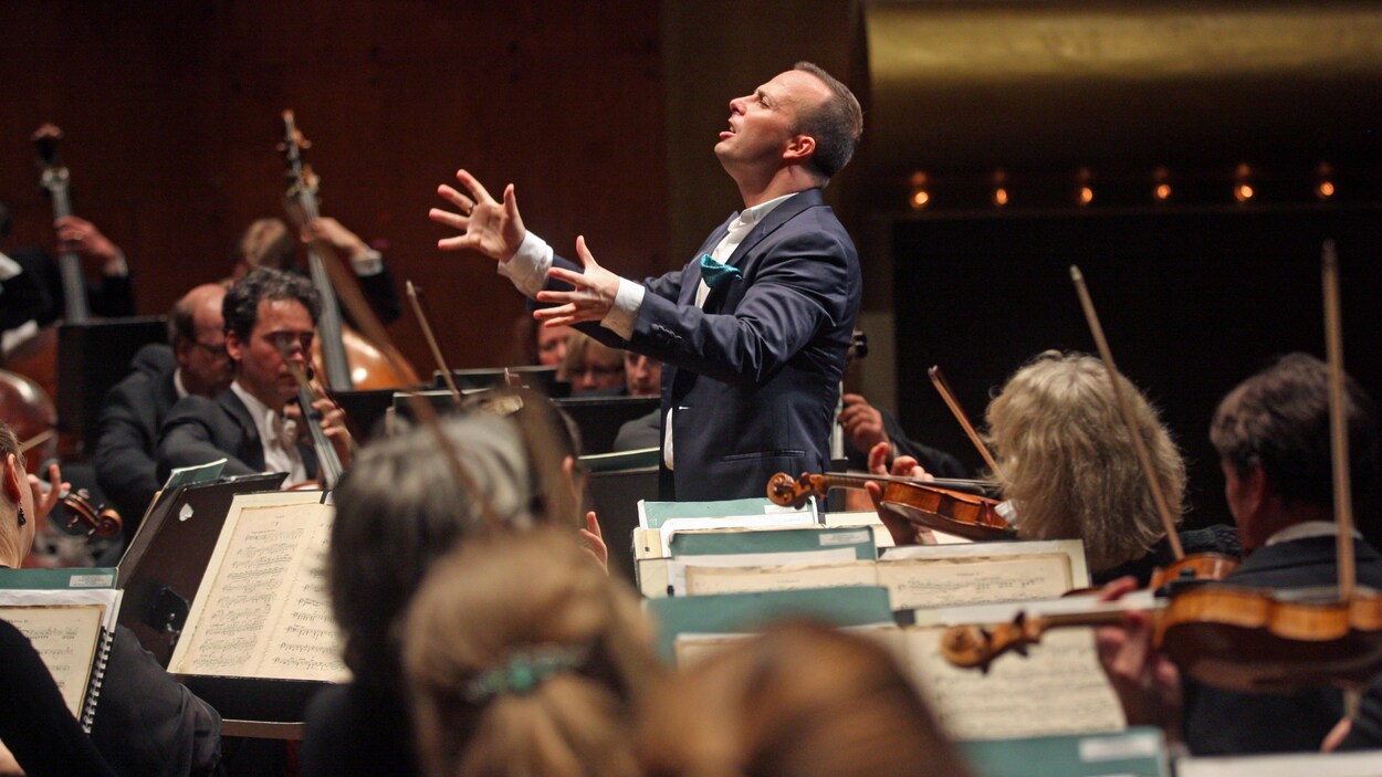 Un homme dirige avec émotion un orchestre le 22 février 2015. Un homme dirige avec émotion un orchestre le 22 février 2015.