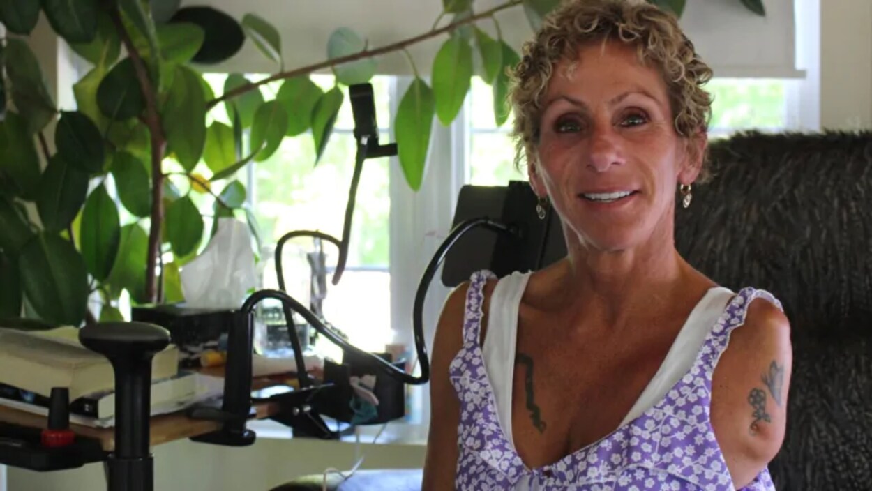 Noëlla Hébert, une femme souriante avec un bras manquant.