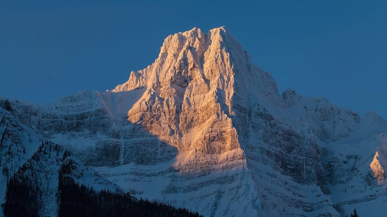 Une montagne escapée est recouverte de neige.