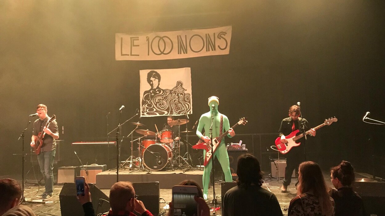 Des gens sur une scène avec des micros et des instruments de musique Des gens sur une scène avec des micros et des instruments de musique
