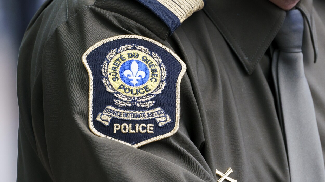 Le logo de la Sûreté du Québec apparaît sur la manche d'un uniforme.