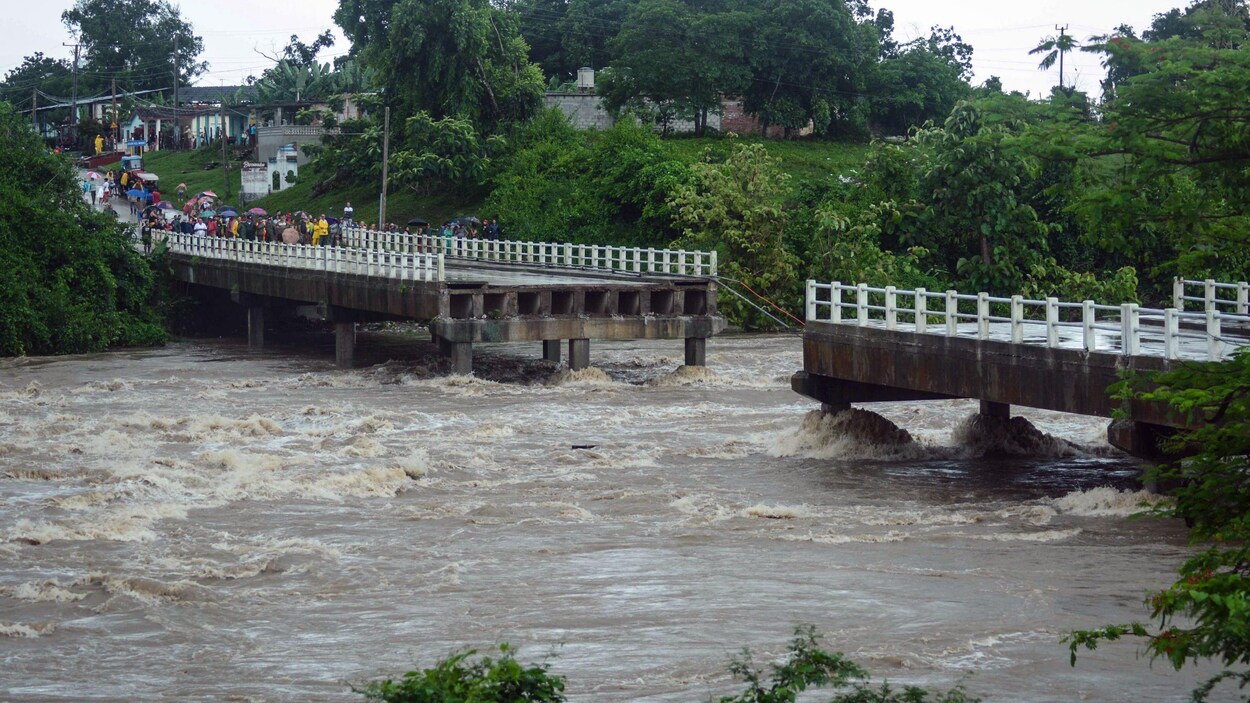 Un pont emporté par une rivière en crue.