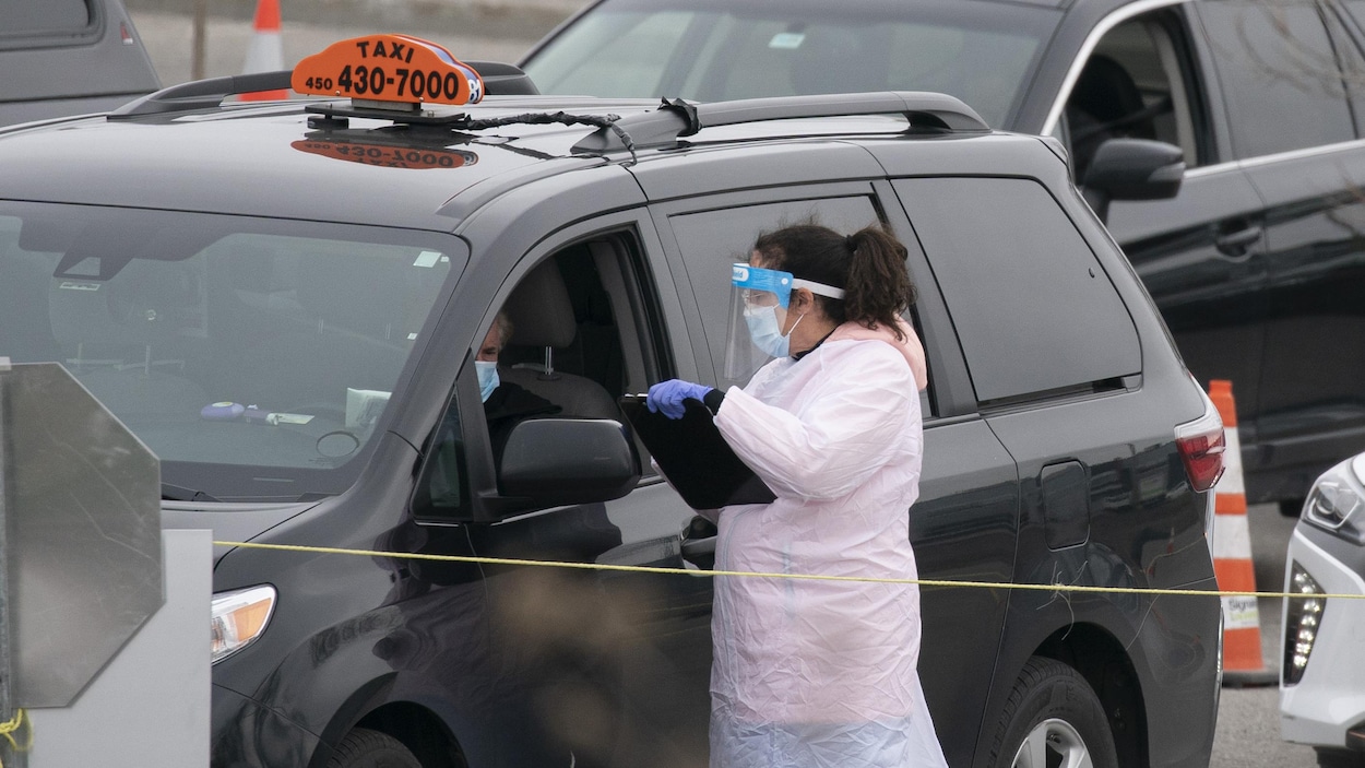 Une préposée de la santé fait passer un test de dépistage à un chauffeur de taxi.