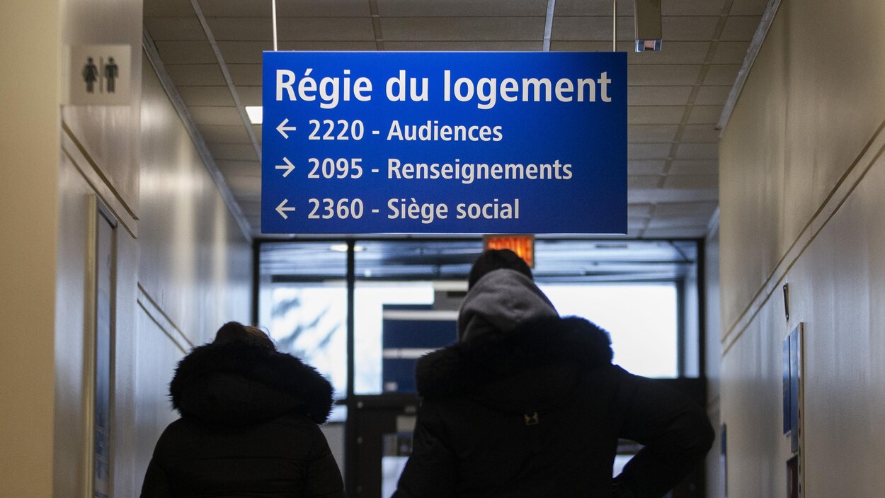 Des femmes marchent dans un corridor de la Régie du logement.